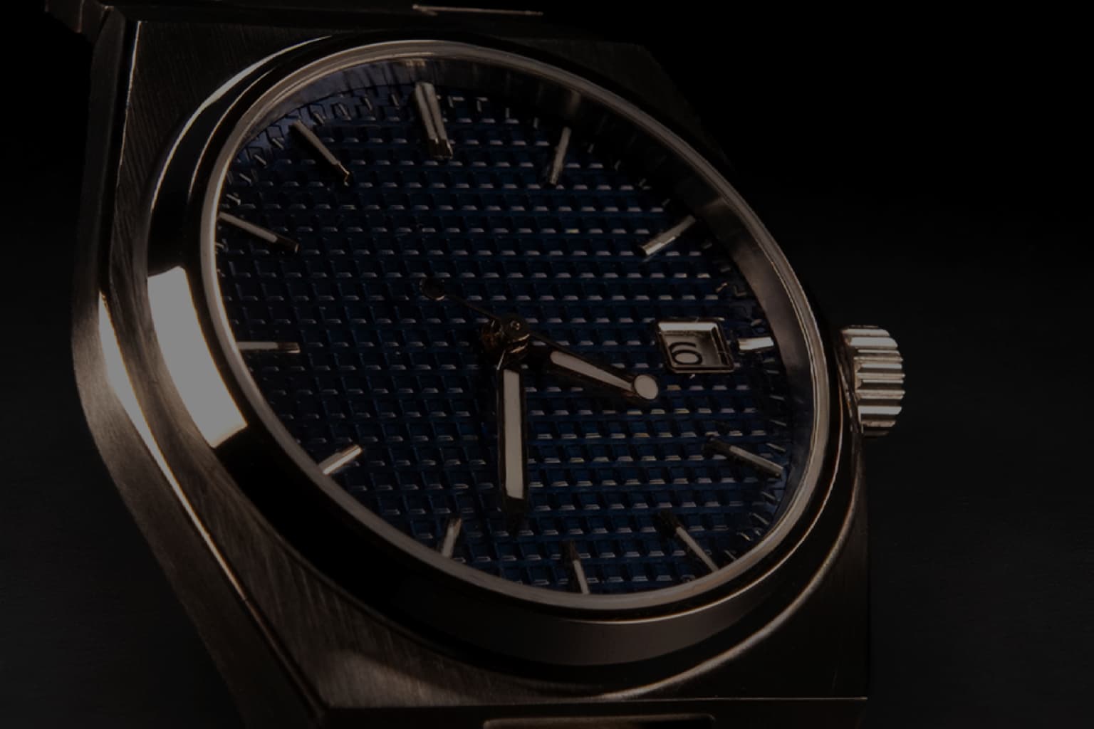Forge & Crown Sport Watch with blue patterned dial, silver hands and indices on a black background.